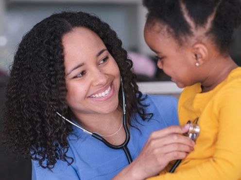 provider with kid and stethoscope
